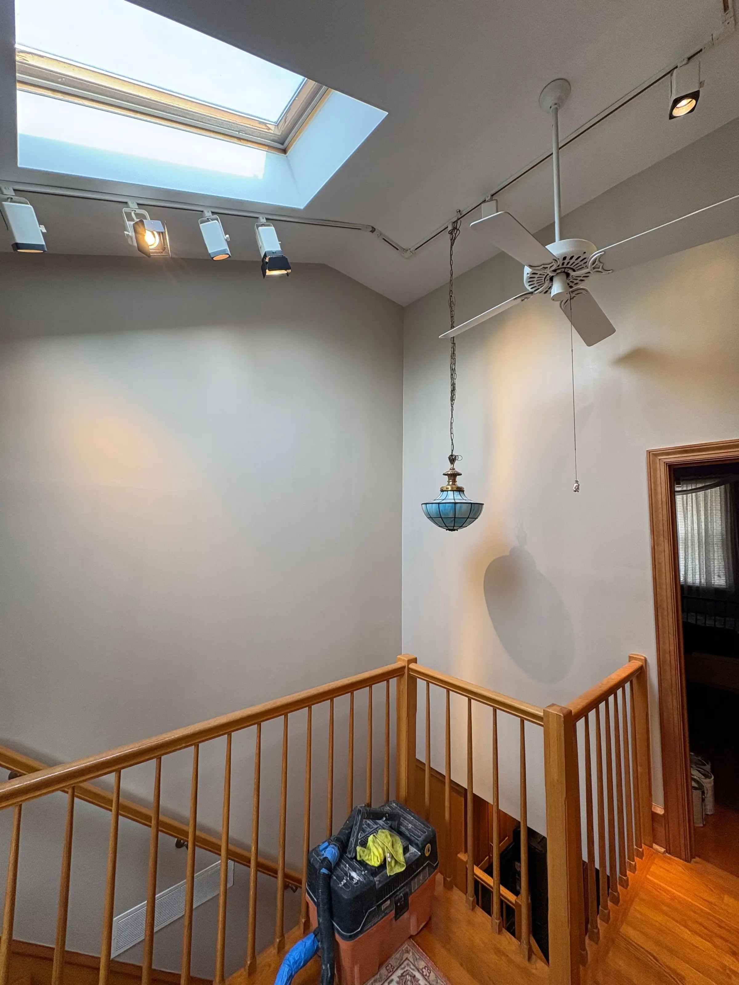 Stairwell with skylight, freshly painted white walls and ceiling
